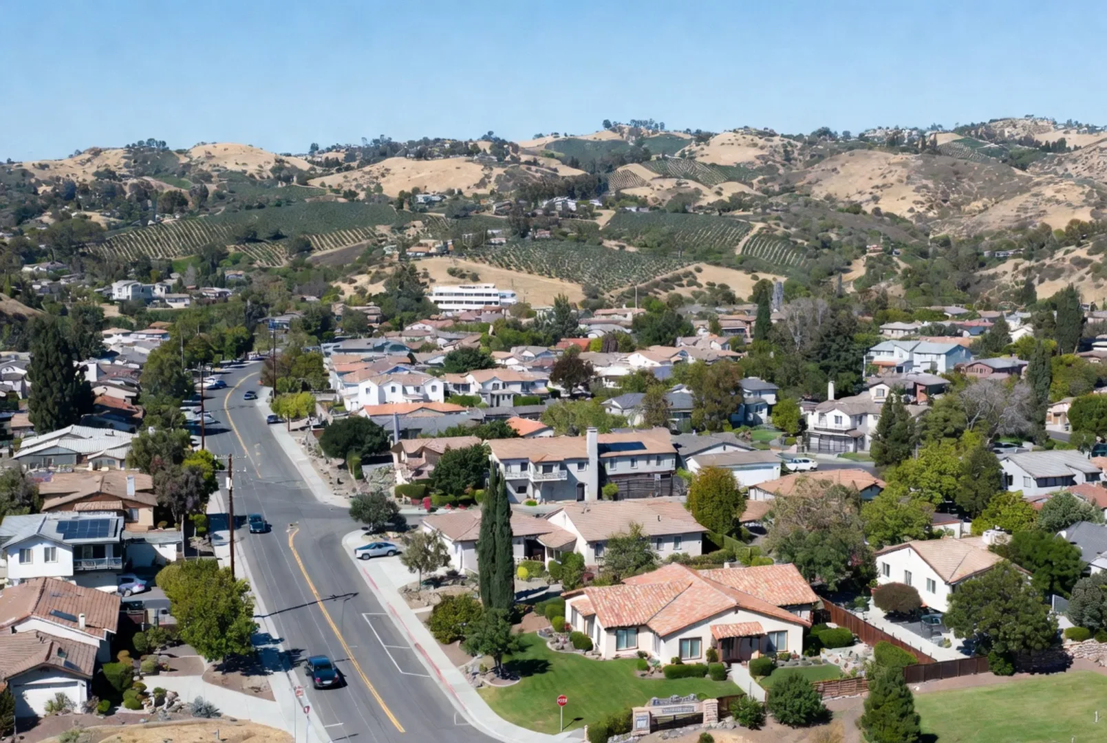 Aerial view of De Luz homes with avocado groves and rolling hills, Temecula CA