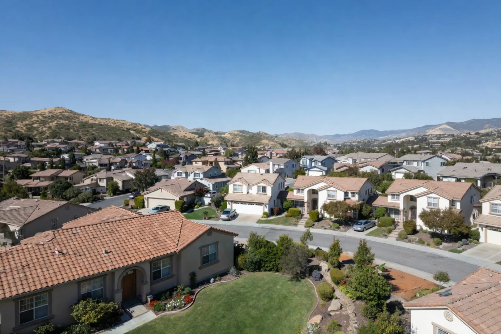 Aerial view of a Temecula subdivision with tile-roofed homes stretching toward rolling hills, the kind of post-1990 tract funded through a Community Facilities District